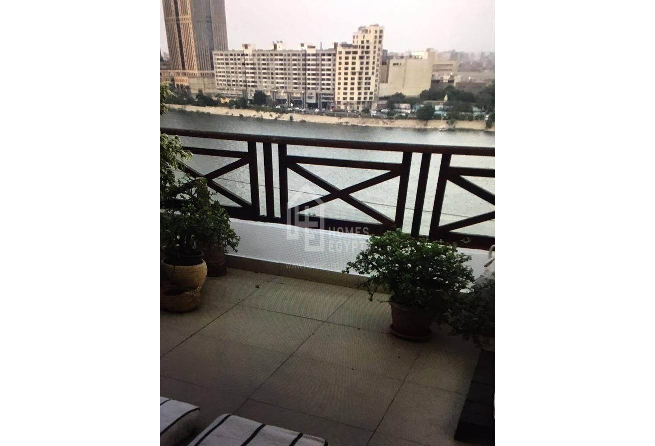 A Very Well Lit, Fully Furnished Apartment in Zamalek 
With a Large Terrace Over Looking the Nile.
the Place has a High Ceiling and Wooden Floor.
 Features; 
1 Bedroom, 
1 Bathrooms, 
a Living Room and
 a Well Equipped Kitchen and has a nile view>
Zamalek is an affluent district of western Cairo encompassing the northern portion of Gezira Island in the Nile River, Zamalek is one of the affluent residential districts in Greater Cairo, Many non-Egyptians live in Zamalek. The quiet, leafy streets and 19th-century apartment blocks and villas make this one of the most attractive parts of the city and a favored residential location for many of Cairo's European expatriates. It is also the district of many fine restaurants, bars and cafes, including traditional open-air ahwas and European cappuccino bars.