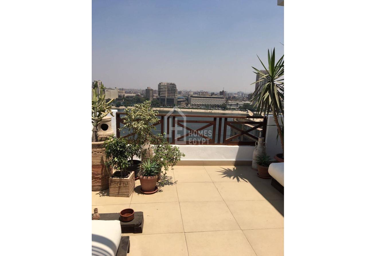 A Very Well Lit, Fully Furnished Apartment in Zamalek 
With a Large Terrace Over Looking the Nile.
the Place has a High Ceiling and Wooden Floor.
 Features; 
1 Bedroom, 
1 Bathrooms, 
a Living Room and
 a Well Equipped Kitchen and has a nile view>
Zamalek is an affluent district of western Cairo encompassing the northern portion of Gezira Island in the Nile River, Zamalek is one of the affluent residential districts in Greater Cairo, Many non-Egyptians live in Zamalek. The quiet, leafy streets and 19th-century apartment blocks and villas make this one of the most attractive parts of the city and a favored residential location for many of Cairo's European expatriates. It is also the district of many fine restaurants, bars and cafes, including traditional open-air ahwas and European cappuccino bars.